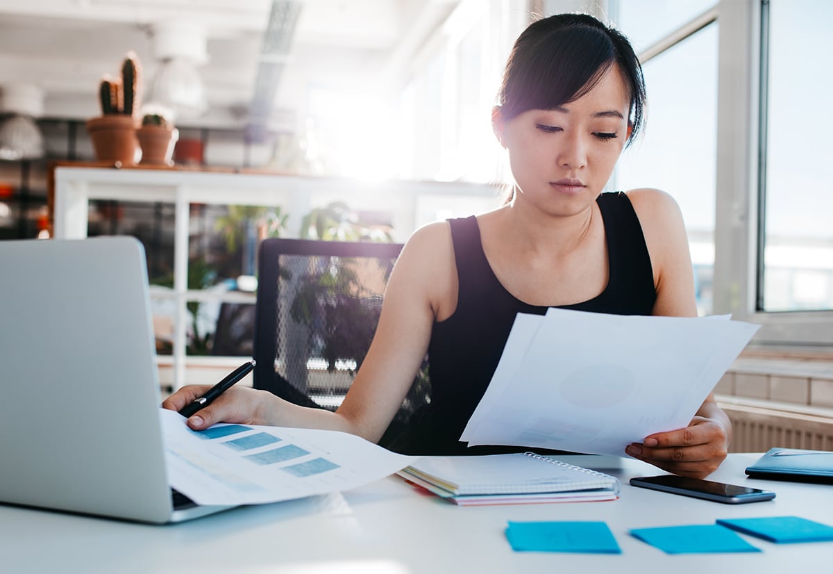 A women at her home office analyzing a business plan