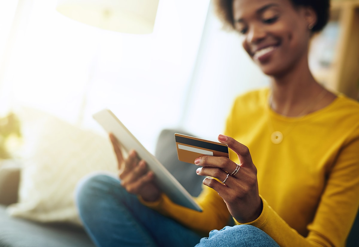 A woman at home making an online purchase on her tablet.