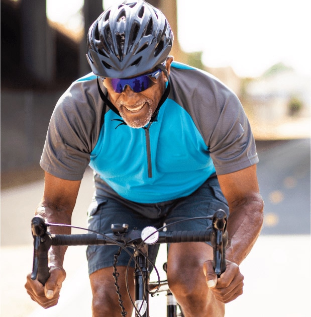 Man on bicycle pedaling hard.